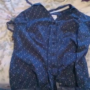 A blue collared short sleeved shirt with a fun pattern